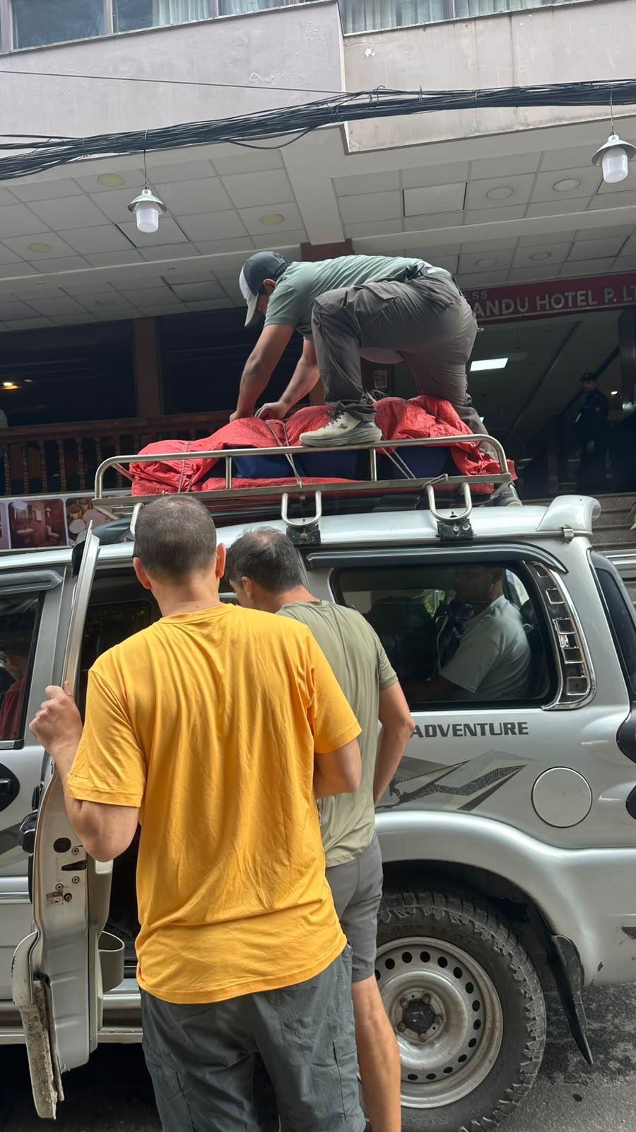 Guide loading luggage onto the jeep roof in Thamel before the Manaslu Circuit Trek